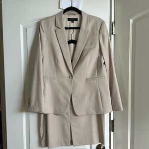 Like new Tahari size 14 tan pinstripe skirt suit with front vent slit